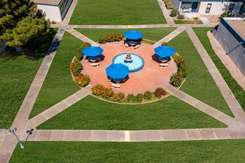 arial view of a fountain in the middle of a garden
